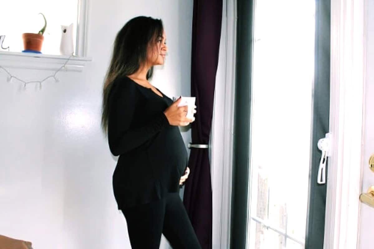 Pregnancy and coffee by window