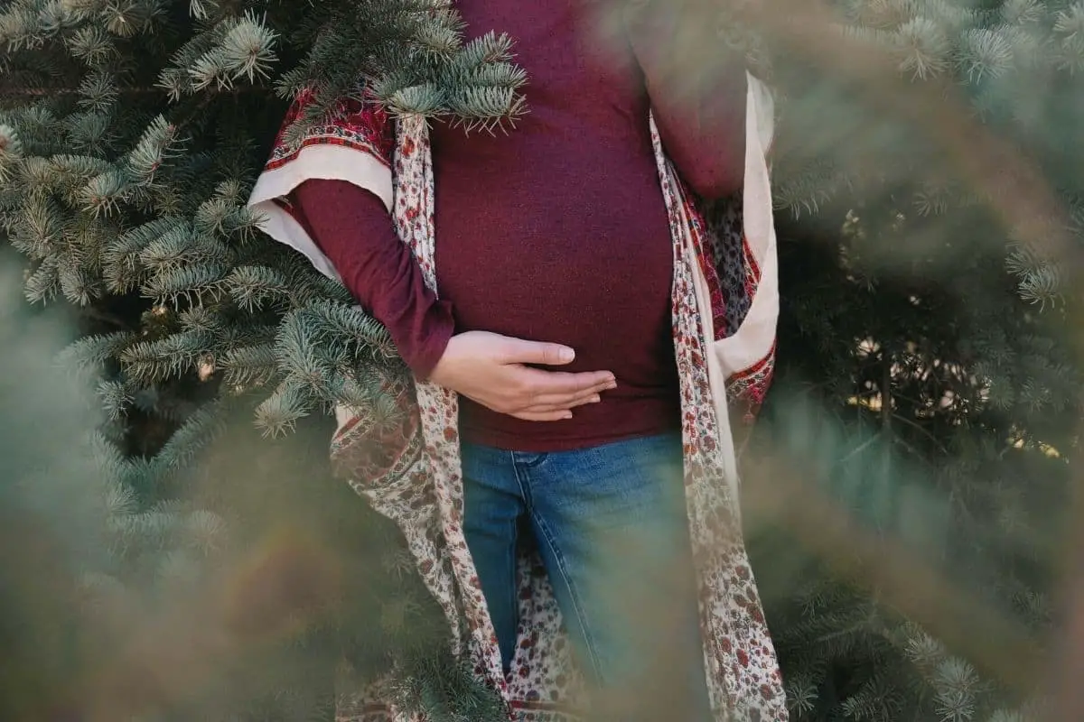 pregnant woman wearing cute winter maternity clothes