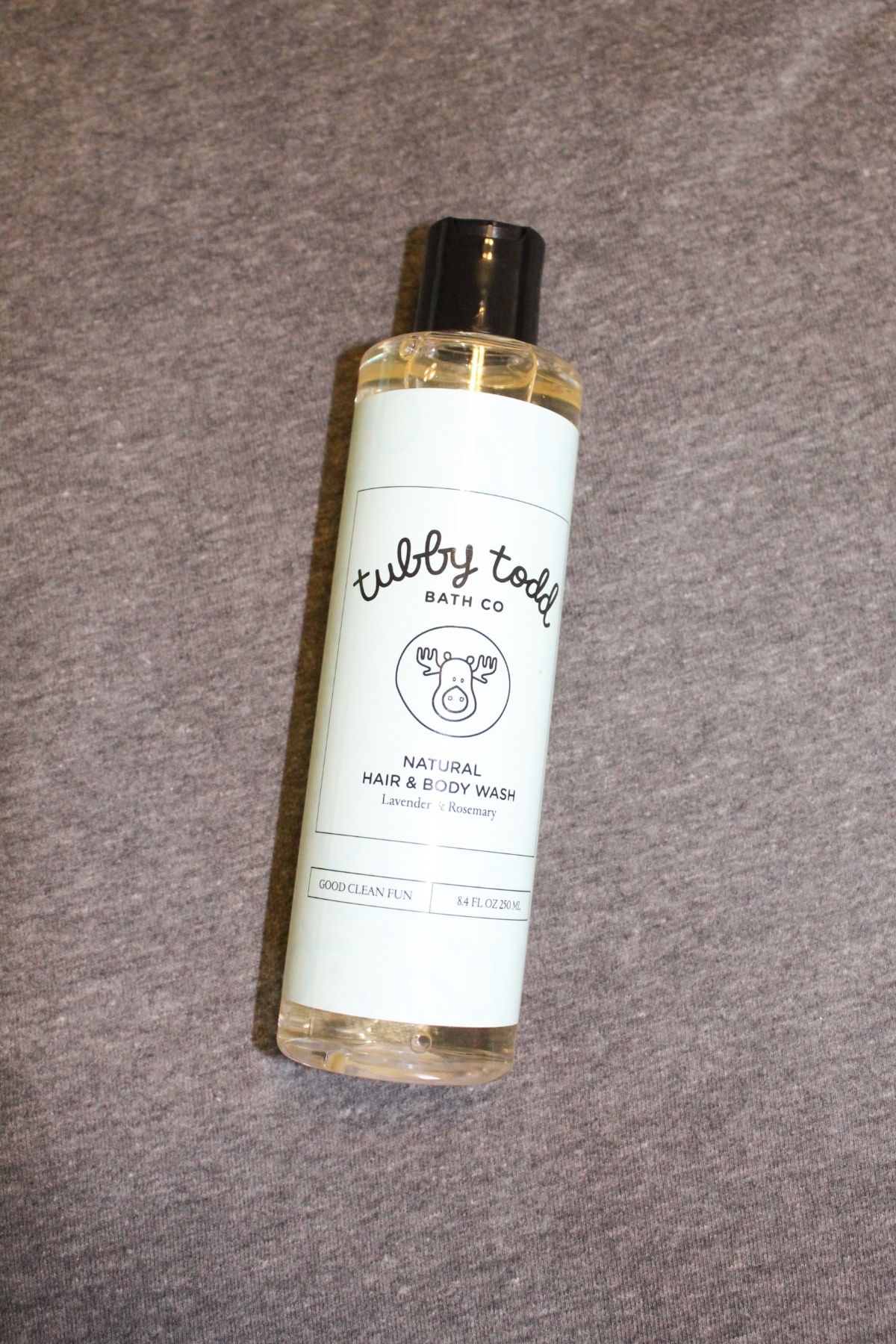 tubby todd hair and body wash lavender rosemary scent on a grey cloth background
