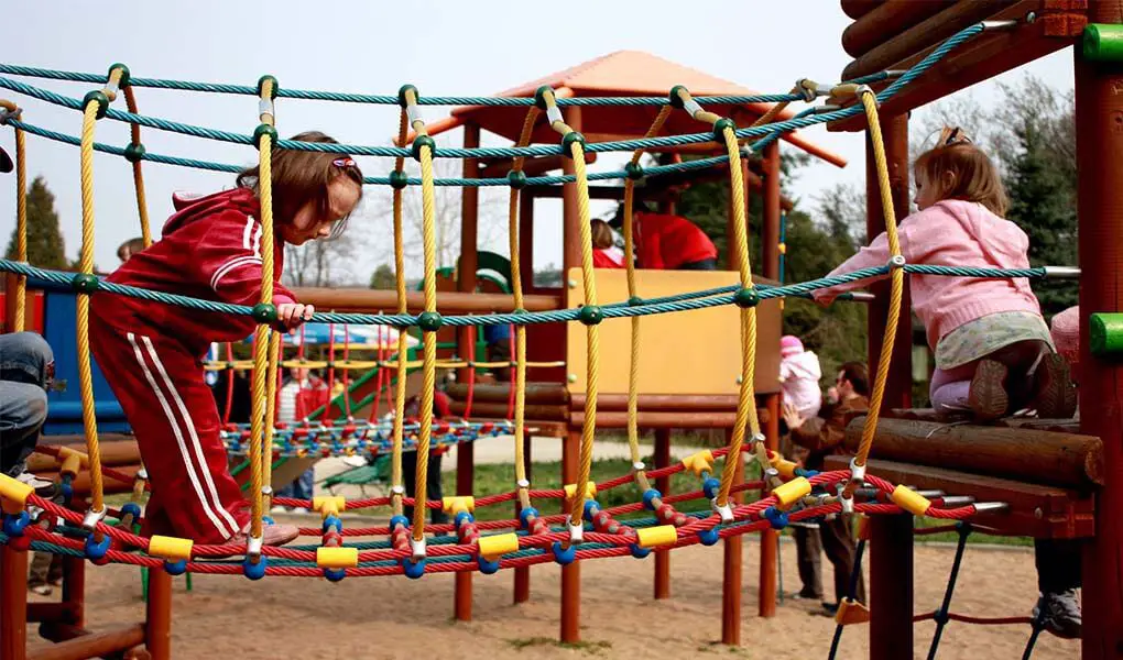 Toddlers playing on a climbing toy