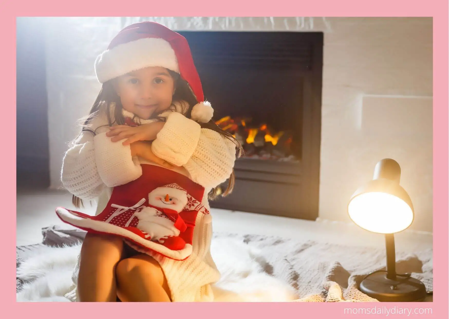 Toddler holding her Christmas stocking.