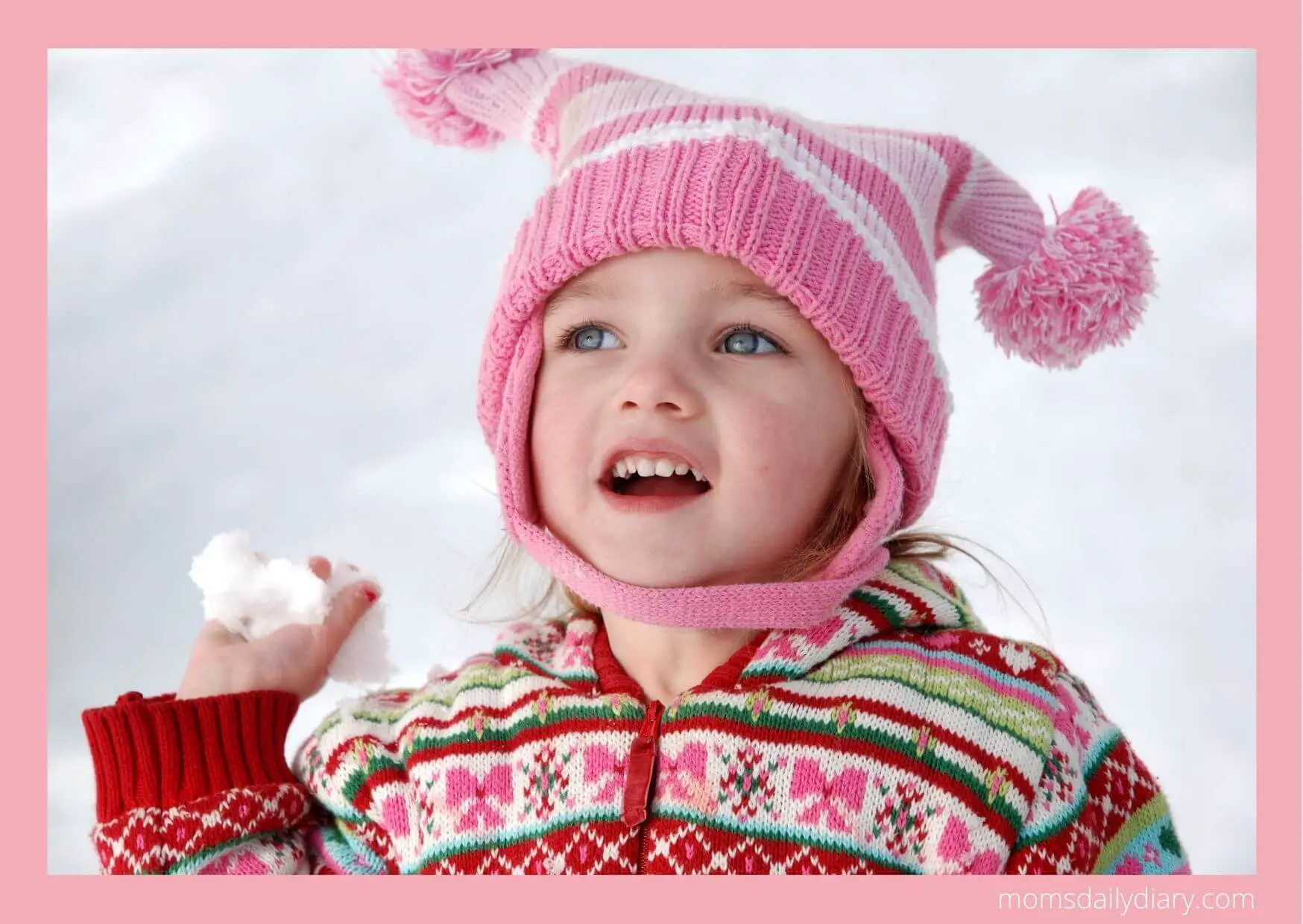 Winter activities: Toddler with a snowball