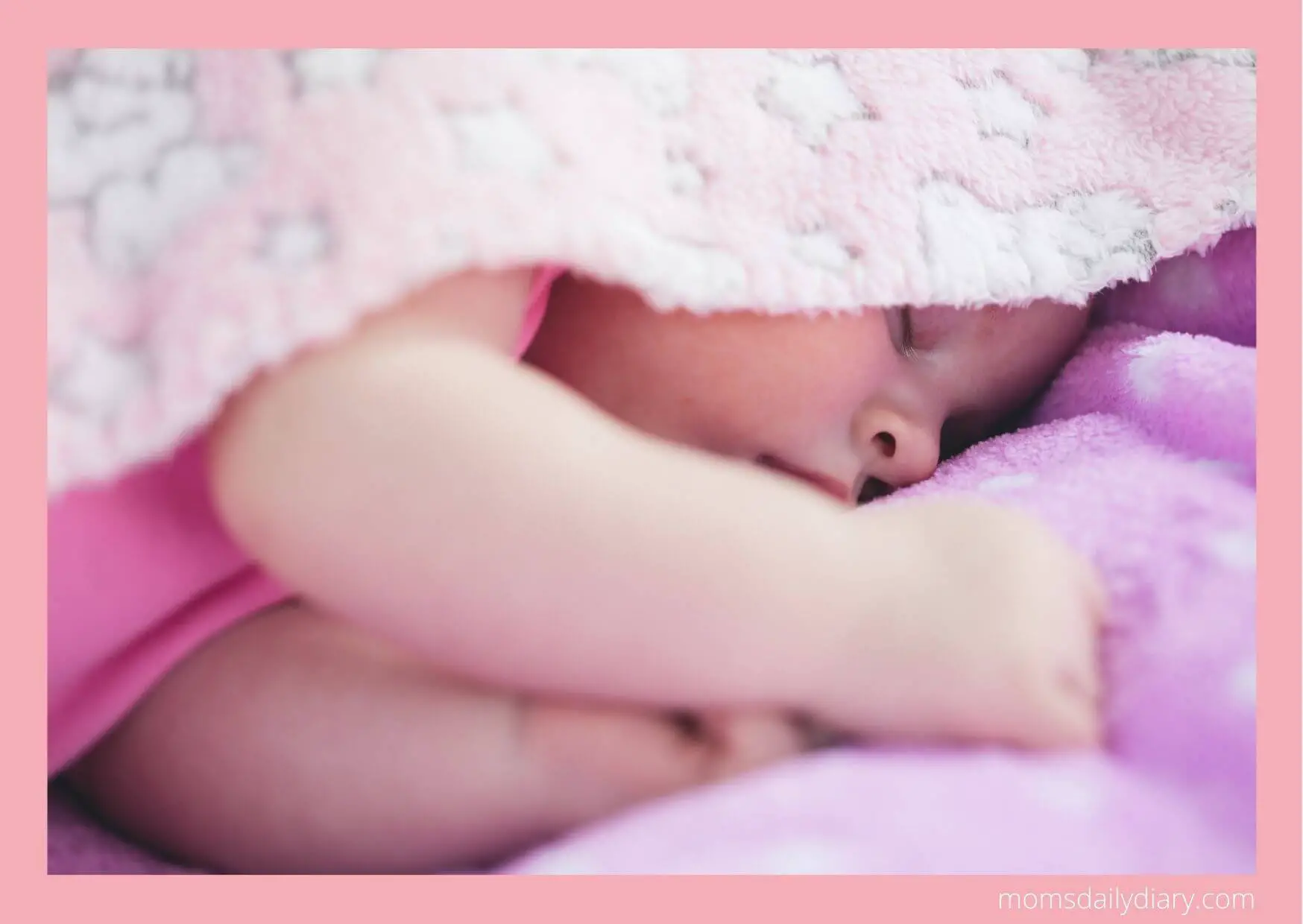 Baby sleeping under a blanket